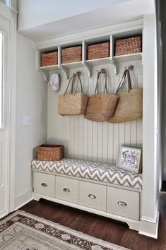 a white bench with baskets on it in a room