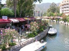 boats are parked along the side of a river