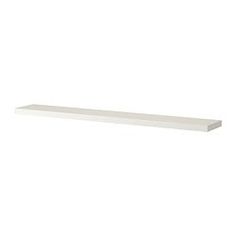 a white shelf sitting on top of a wall