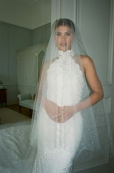 a woman wearing a wedding dress and veil