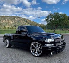 a black truck parked in a parking lot