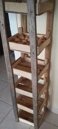 a wooden shelf filled with bread on top of a tiled floor