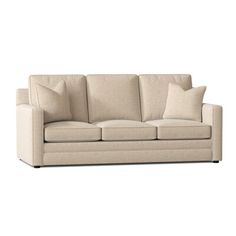 a beige couch with pillows on it