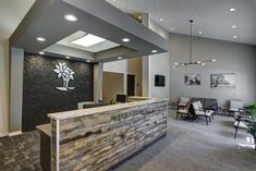 an office lobby with a stone counter and chairs