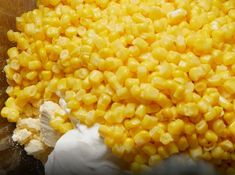 corn is being mixed together in a bowl