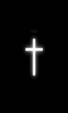 a white cross is glowing in the dark