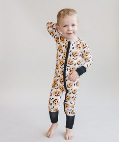 Halloween just got sweeter! Our Halloween bamboo zip romper is the perfect blend of style, softness, and functionality for your little bundle of joy. Your little one will stay cozy and comfortable, whether it's playtime, nap time, or cuddle time. Oh-so-soft and stretchy Fold over mittens & fold over footies The 2-way zipper makes diaper changes a breeze 95% viscose from bamboo; 5% spandex Machine wash cold and tumble dry low Not treated with flame retardants or chemicals Designed with a snug fit Cuddle Time, Pajama Romper, Romper Black, Christmas Blankets, Bundle Of Joy, Skirt Jumpsuit, Resort Collection, Black Romper