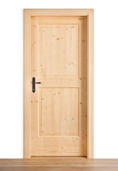 an open wooden door on a white wall