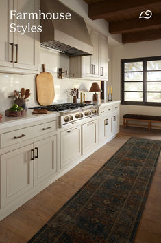 a large kitchen with white cabinets and wood flooring is featured in the magazine farmhouse style styles