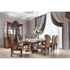 a dining room table with chairs, china cabinet and chandelier in the corner