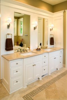 a large bathroom with double sinks and mirrors