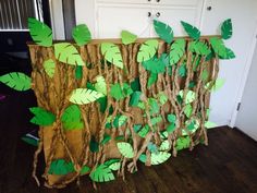 a brown bag with green leaves on it sitting in front of a white wall and wooden floor