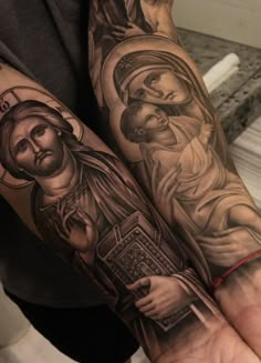 a man with tattoos on his arm holding a cross and jesus's face in the center