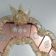 an ornate mirror with gold and silver decorations on it