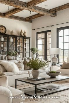 a living room filled with furniture and lots of windows