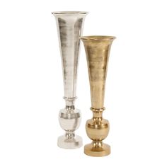 two silver and gold vases sitting next to each other on top of a white surface