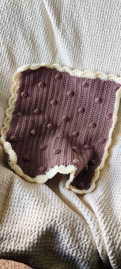 a knitted blanket with holes in the middle