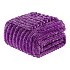 a pile of purple towels sitting on top of each other in front of a white background