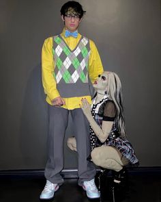 a man standing next to a creepy doll