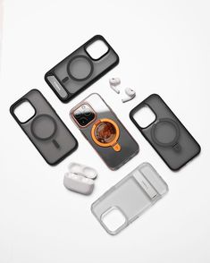 an assortment of cell phones and accessories on a white surface, including earbuds