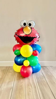 a sesame street character balloon stack on the floor