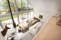 the interior of a modern house with wood floors and white walls is shown from above