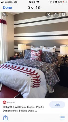 a baseball themed bed in a bedroom with striped wallpaper and red accents on the headboard