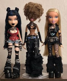 three dolls are standing next to each other