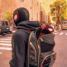 a person with a spider - man backpack on the street