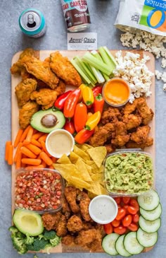 a platter filled with chicken, veggies, and other foodstuffs