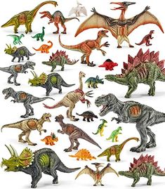 an assortment of toy dinosaurs on a white background