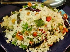 rice and vegetables are mixed together on a blue plate