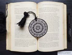 an open book with a tassel hanging from it