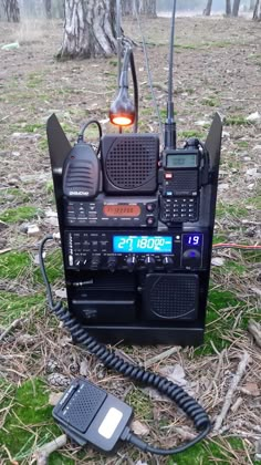 an old radio sitting on the ground next to a telephone