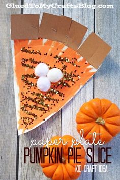 a piece of paper plate pumpkin pie slice on top of a wooden table next to mini pumpkins