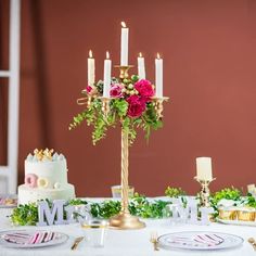 a table with candles and flowers on it