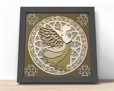 an intricately designed paper art piece with a bird on it's head and wings