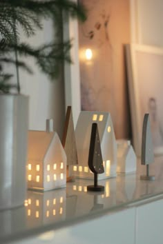 some white candles are sitting on a shelf