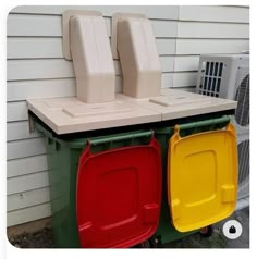 two air conditioners sitting next to each other in front of a house