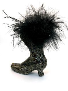 Fancy lady's boot from another century is a ceramic piece covered with fabric that looks like black lace. The top edge is trimmed with black feathers. Use this unique boot for holding your makeup brushes or pencils and pens. This small boot cup is 6 inches tall. Every Critter n Calico will come with a small sample of the fabric used in the design.  ~ This is an introduction to my art, Critters-n-Calico. The "Critters" started 20+ years ago when I needed something to do as I recovered from a car accident. The technique was totally developed by me. I'd never taken a class and had never seen another art process to develop the critters.  All Critters-n-Calico starts with a ceramic figurine. I have also used interesting figurines made from paper mâché or plaster of Paris. I have even covered a Unique Boots, Small Figurines, Black Boots Women, Ceramic Figurines, Black Feathers, Makeup Brushes, White Lace, Collectible Figurines, Black Boots