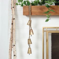 the bells are hanging from the wooden shelf