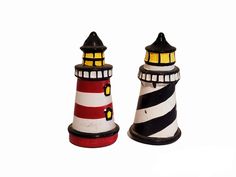 two small lighthouses sitting side by side on top of each other in front of a white background