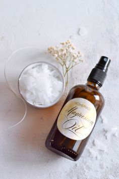 a bottle of liquid sitting next to a bowl of ice