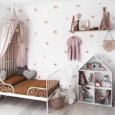 a child's bedroom decorated in pink and white