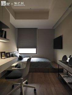 a bedroom with a bed, desk and television on the wall next to it's windows