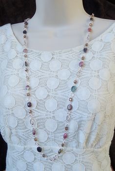 "This popular style necklace is very versatile and can be worn in three ways: simply as a long single-strand necklace, doubled to appear as a double-strand necklace, or hooked mid-way to appear like a lariat necklace (see images). This is a great piece to layer with other pieces. This stunning long strand necklace features beautiful Tourmaline natural stones and crystals. Great for the office or every-day wear. This piece is finished with a simple lobster claw closure and has my signature logo t Long Necklace Outfit, Popular Jewelry Trends, Ruby Jewelry Necklaces, Long Statement Necklace, Long Silver Necklace, Long Beaded Necklace, Jewelry Beaded, Ruby Jewelry, White Necklace