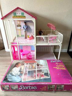 a barbie doll house with furniture and accessories in the box on the floor next to it