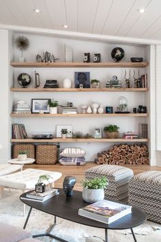 a living room filled with lots of furniture and shelves