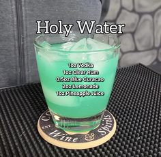 a green drink sitting on top of a coaster