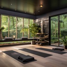 there are many mats on the floor in this yoga room that is very large and has lots of windows